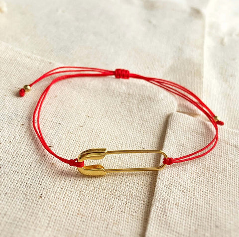 Amulet ( Red string and a Pin)
